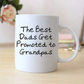 White coffee mug with black text: “The Best Dads Get Promoted to Grandpas”.