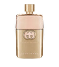 Eau de parfum bottle with gold cap, Gucci Guilty logo and Pour Femme label