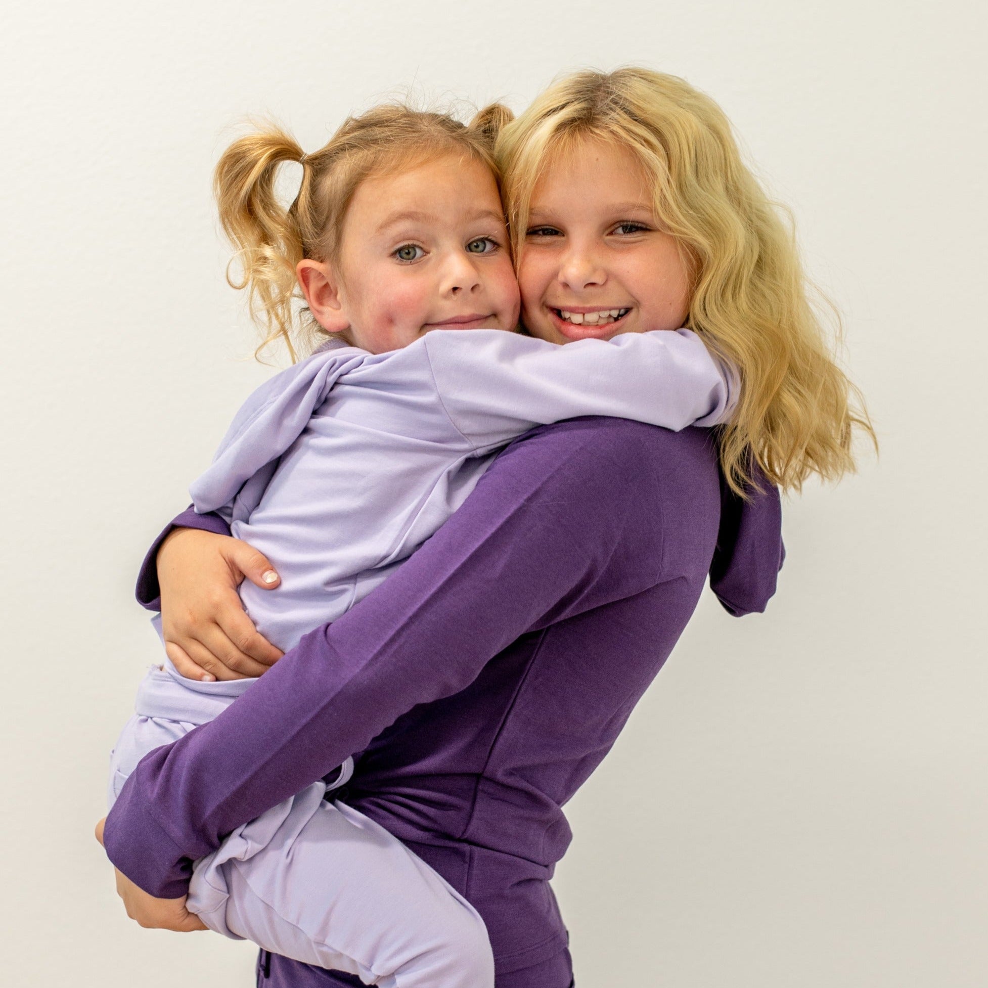 Hooded jogger set in purple, hoodie and joggers worn by two girls
