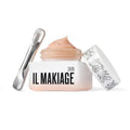 Skincare cream jar with IL MAKIAGE branding, cosmetic roller, and foil tube box