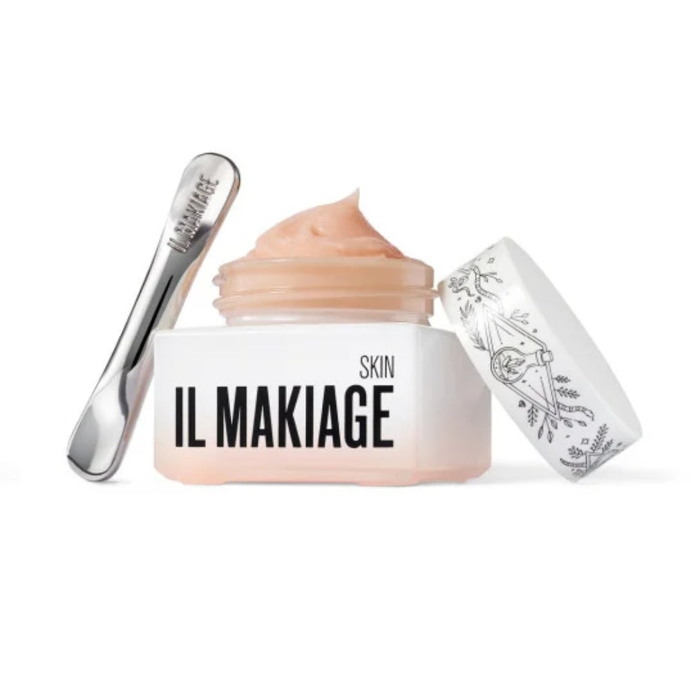 Skincare cream jar with IL MAKIAGE branding, cosmetic roller, and foil tube box