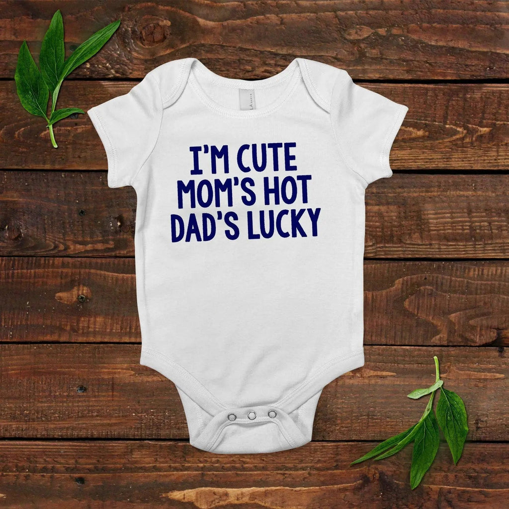 White short-sleeve baby bodysuit with blue “I’m cute mom’s hot dad’s lucky” print