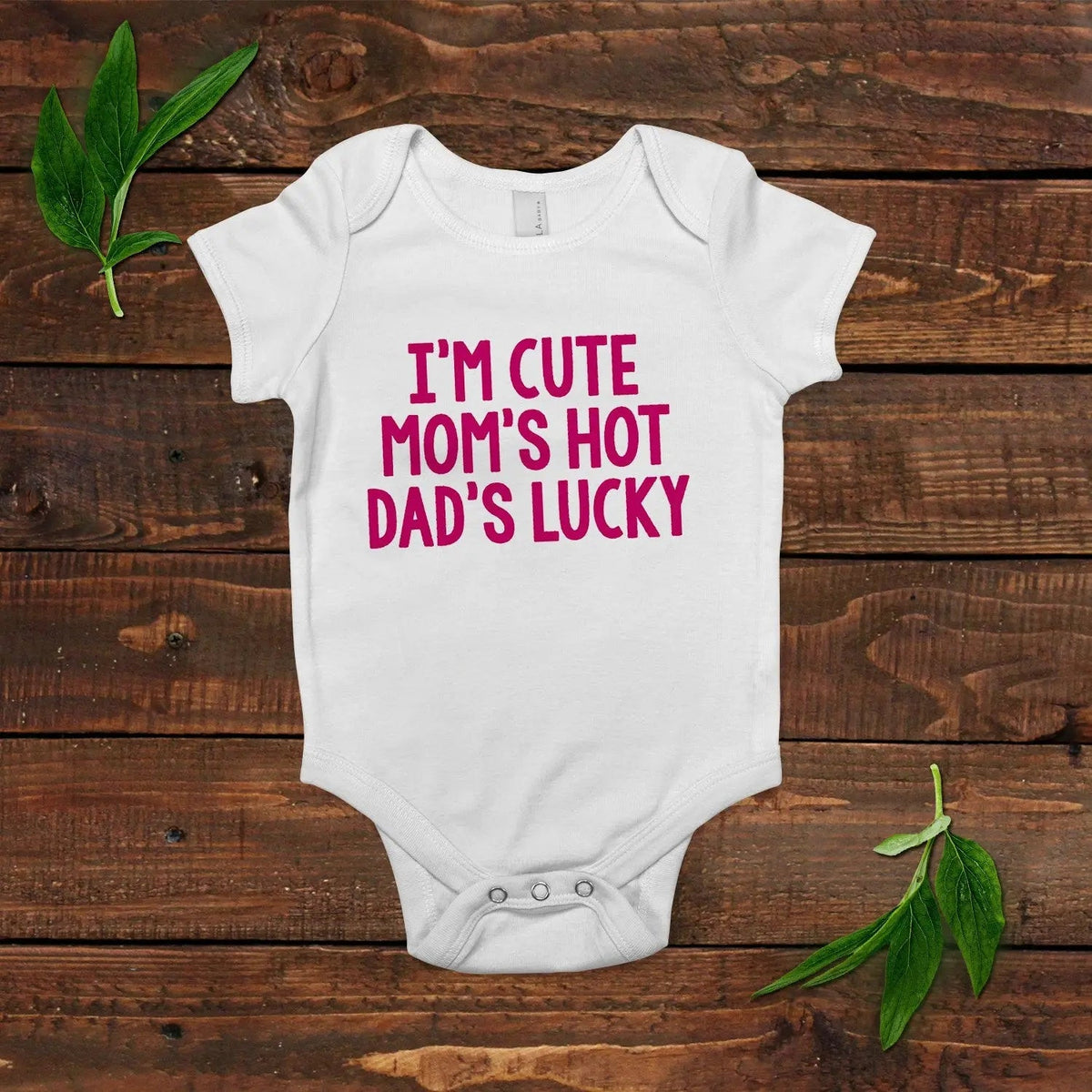 White newborn short-sleeve bodysuit with pink text slogan at the center front