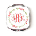 Pocket compact mirror with silver frame, coral floral wreath and red monogram