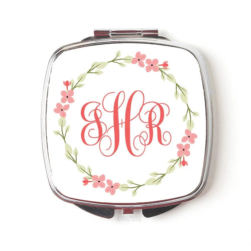 Pocket compact mirror with silver frame, coral floral wreath and red monogram