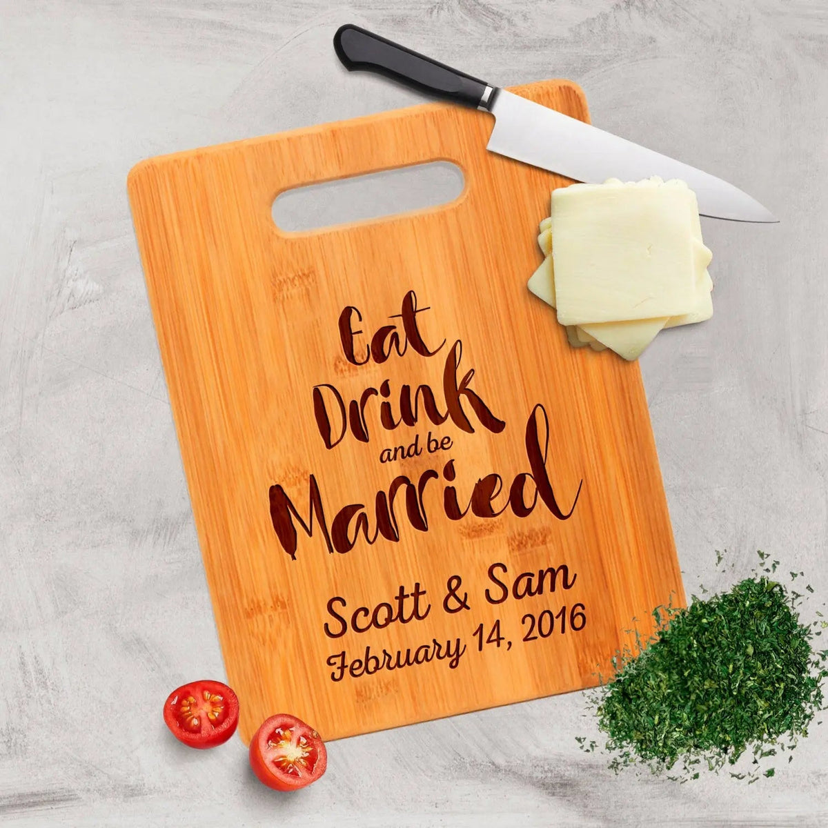 Bamboo cutting board with handle, engraved "Eat Drink and be Married" and wedding date.
