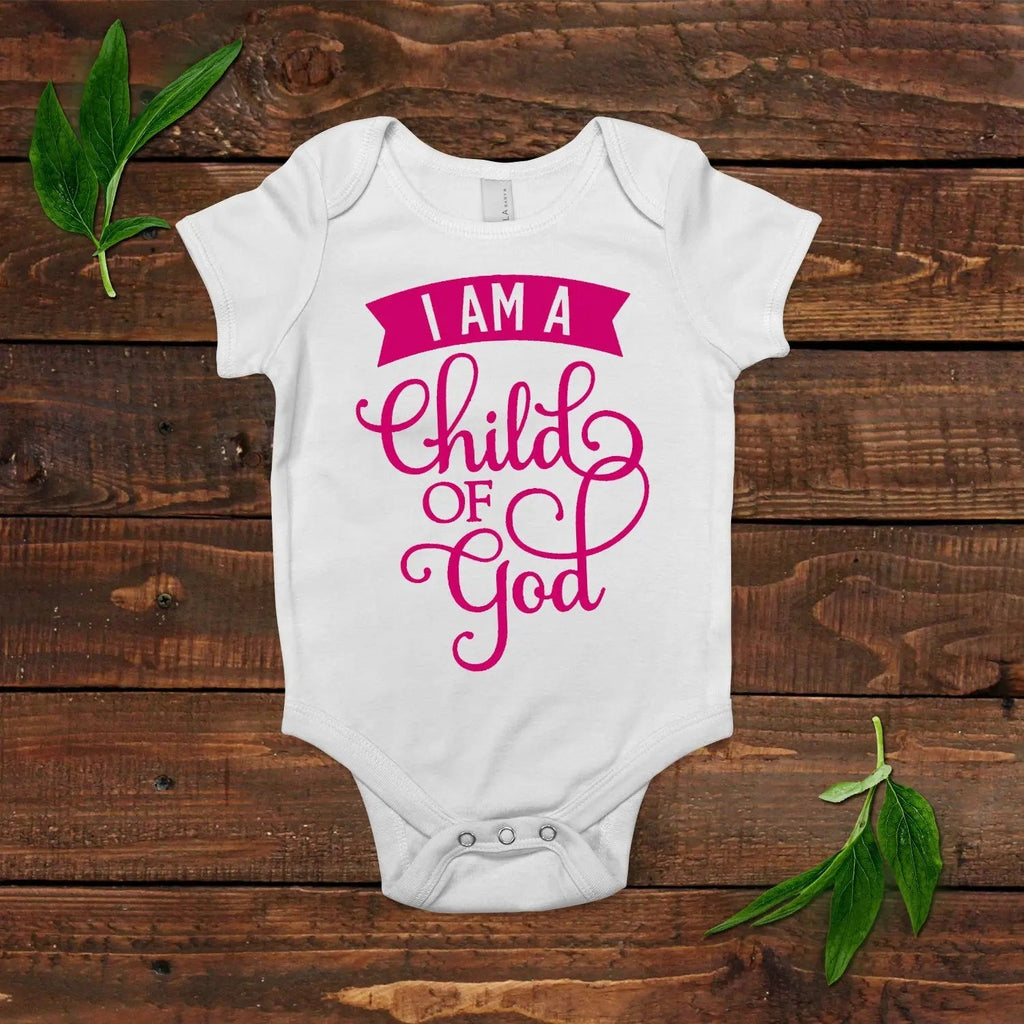 White short-sleeve baby onesie with pink “I AM a child of God” graphic and snap closure