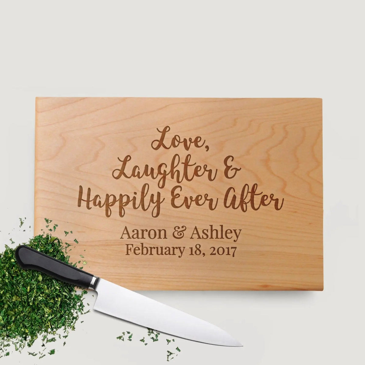 Wood cutting board with engraved 'Love, Laughter & Happily Ever After' and date