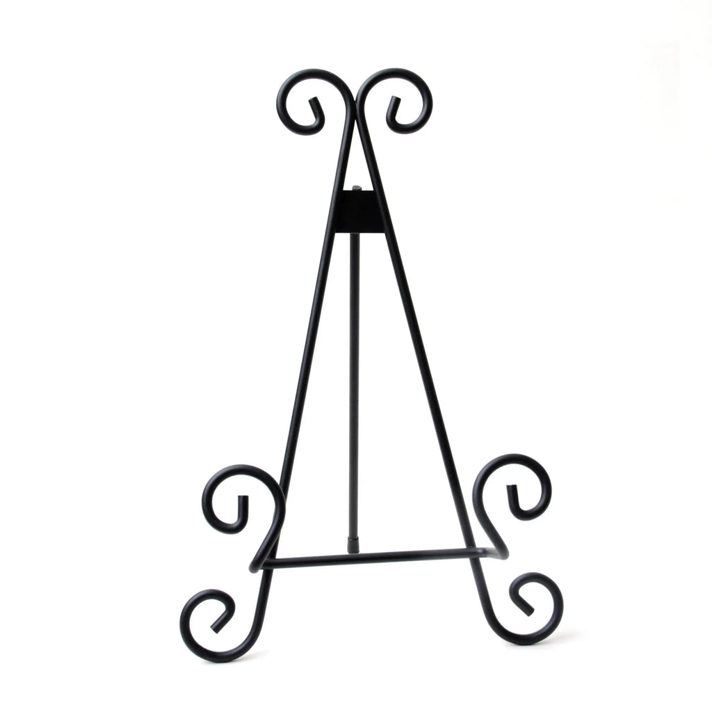 Black metal display stand for a cutting board with curled feet