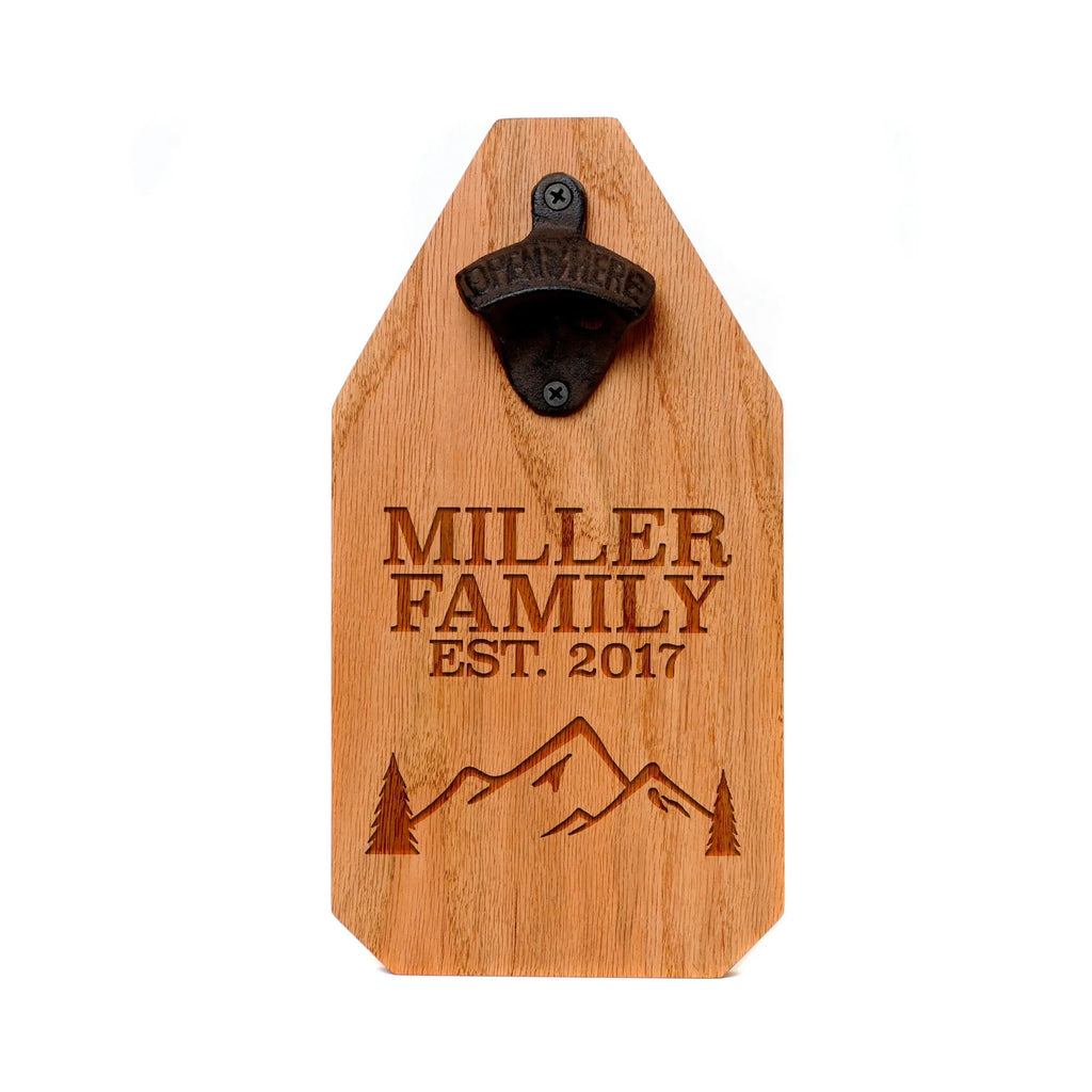 Engraved wood bottle opener sign with family name, mountains, and black opener hardware
