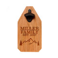 Engraved wood bottle opener sign with family name, mountains, and black opener hardware