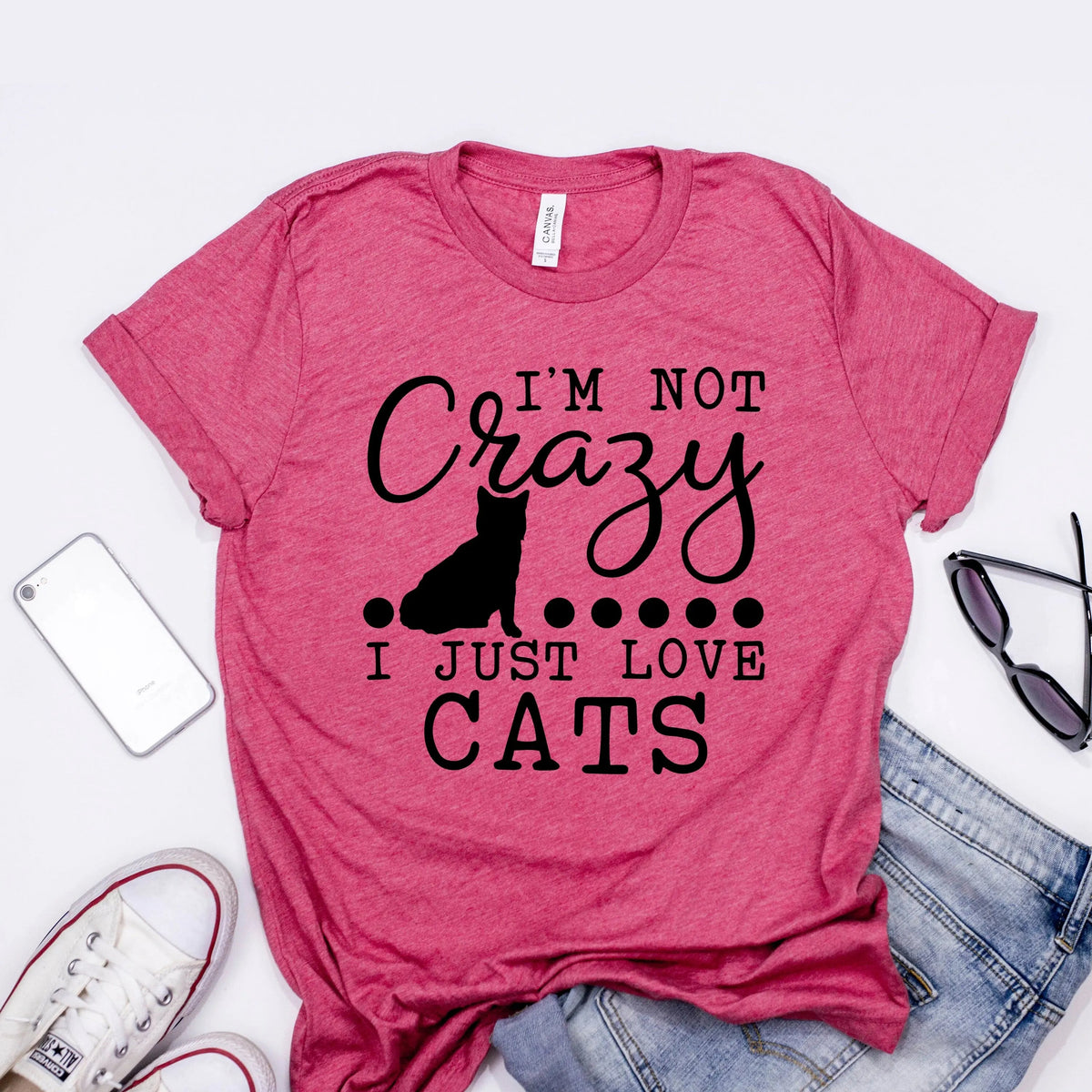 Maroon/pink unisex t-shirt with black cat silhouette and “I’m not Crazy, I just love cats”.