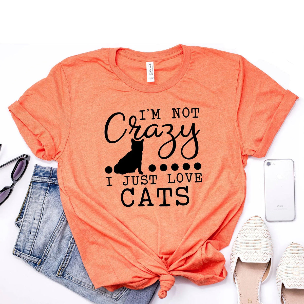 Orange unisex t-shirt with black cat silhouette and text “I’m not Crazy, I just love cats”.