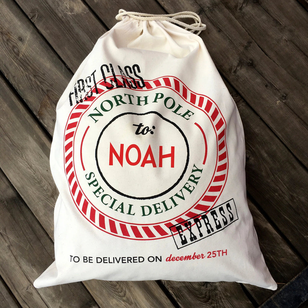 Cream canvas Santa sack with red 'North Pole' seal, 'To: Noah', gathered drawstring.
