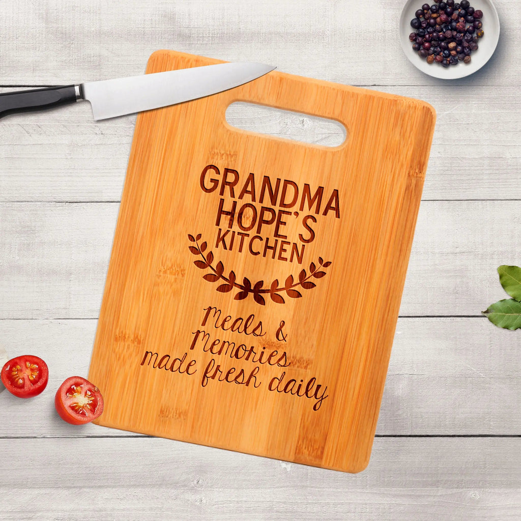 Wood cutting board with handle cutout and engraved “GRANDMA HOPE’S KITCHEN”