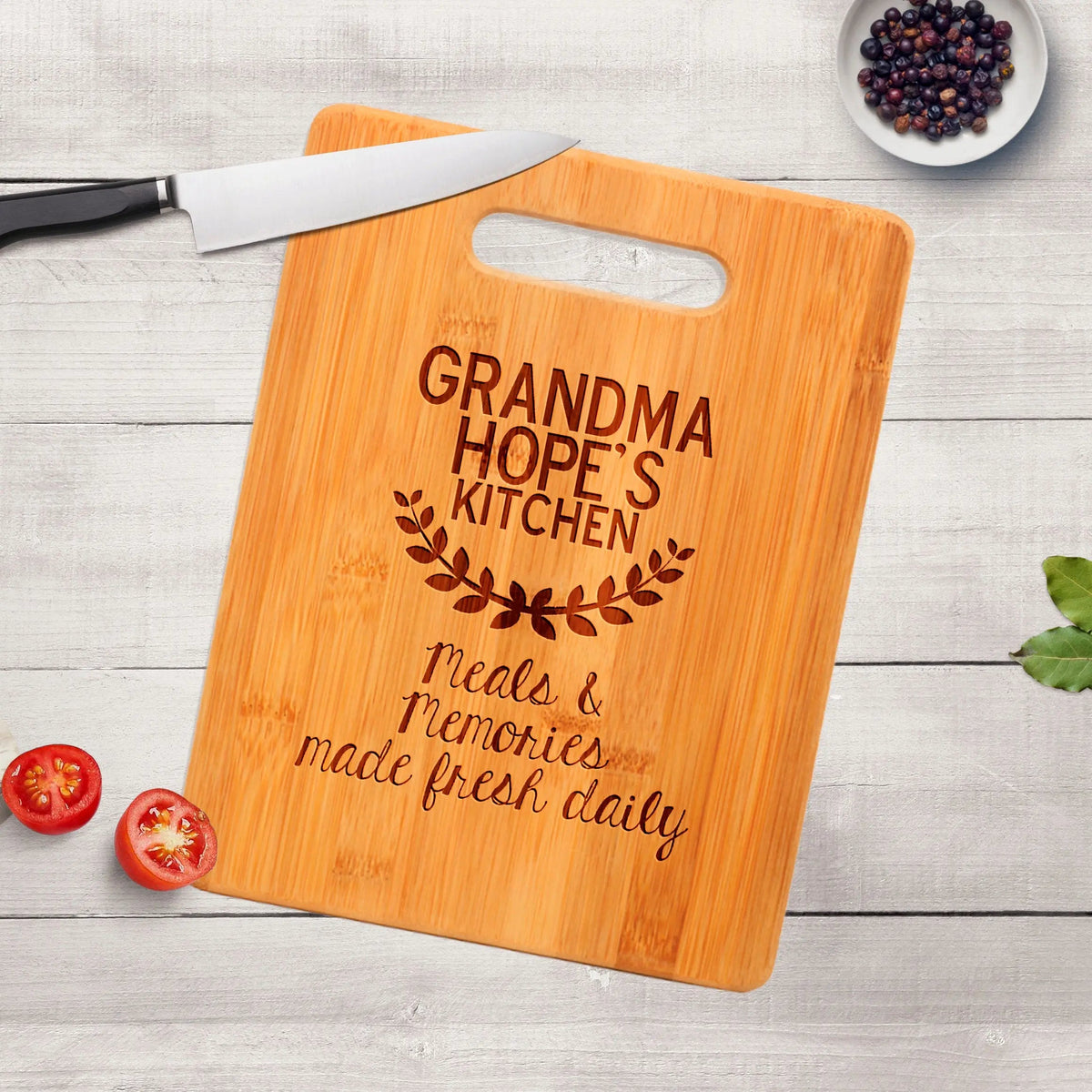 Wood cutting board with handle cutout and engraved “GRANDMA HOPE’S KITCHEN”