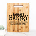 Light wood cutting board with handle, 'SARAH'S BAKERY' lettering