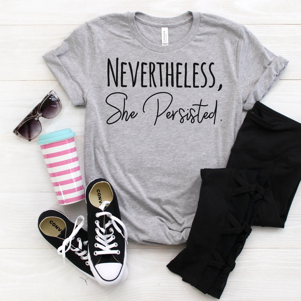 Heather gray women's graphic tee with bold black 'Nevertheless, She Persisted' print