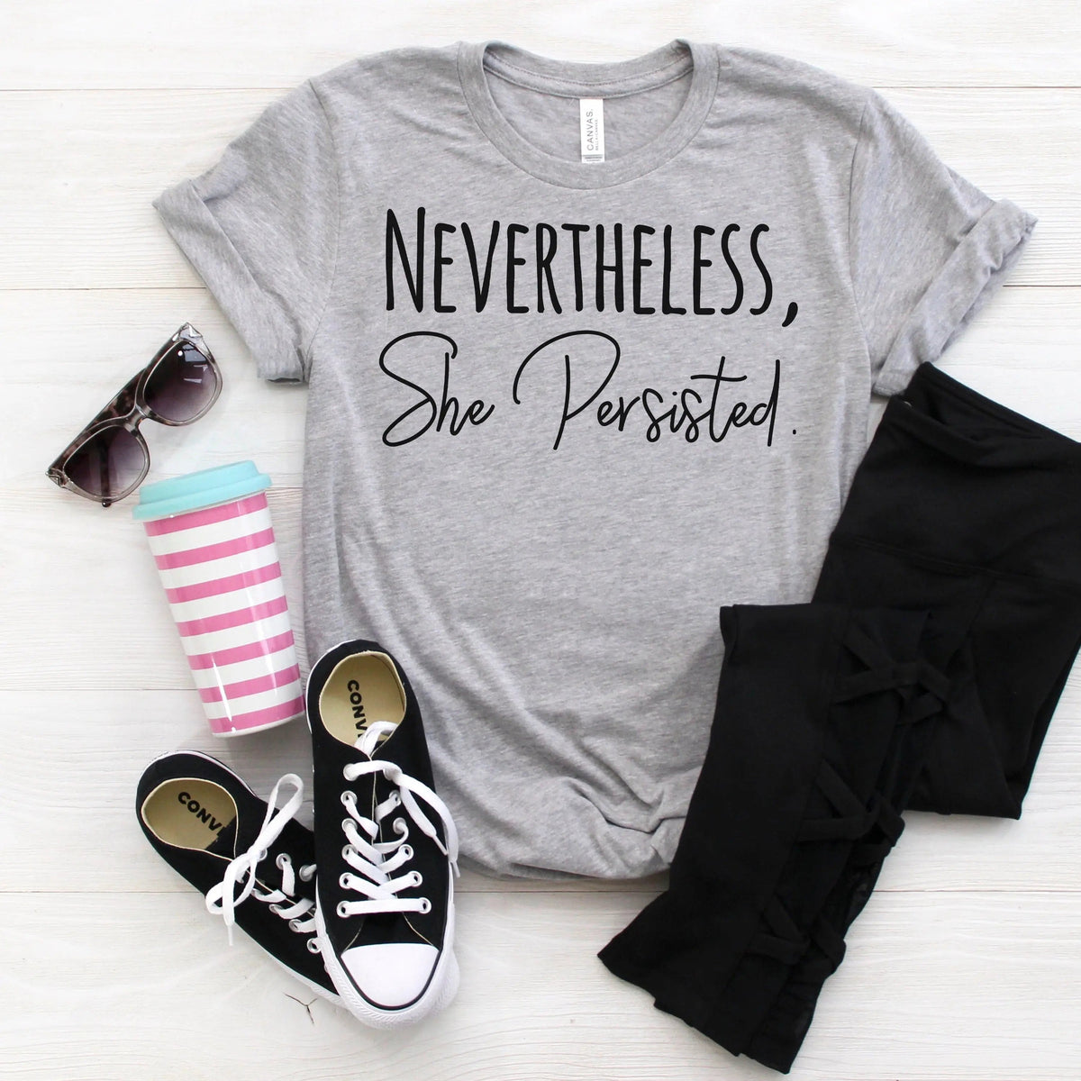 Heather gray women's graphic tee with bold black 'Nevertheless, She Persisted' print