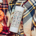 White insulated skinny water bottle tumbler with paper-style 'Date Due' label and straw.