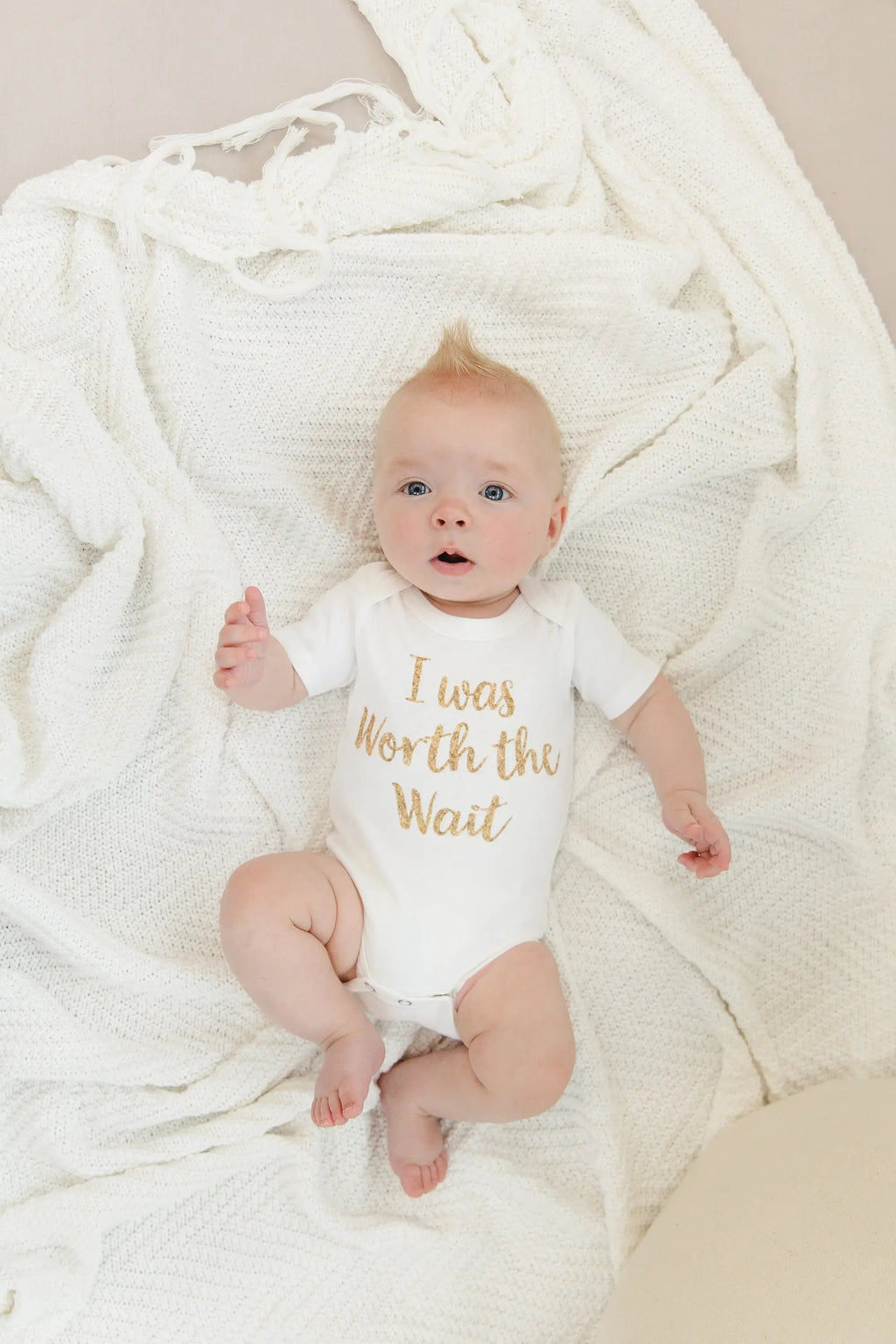White newborn onesie with gold 'I was Worth the Wait' slogan