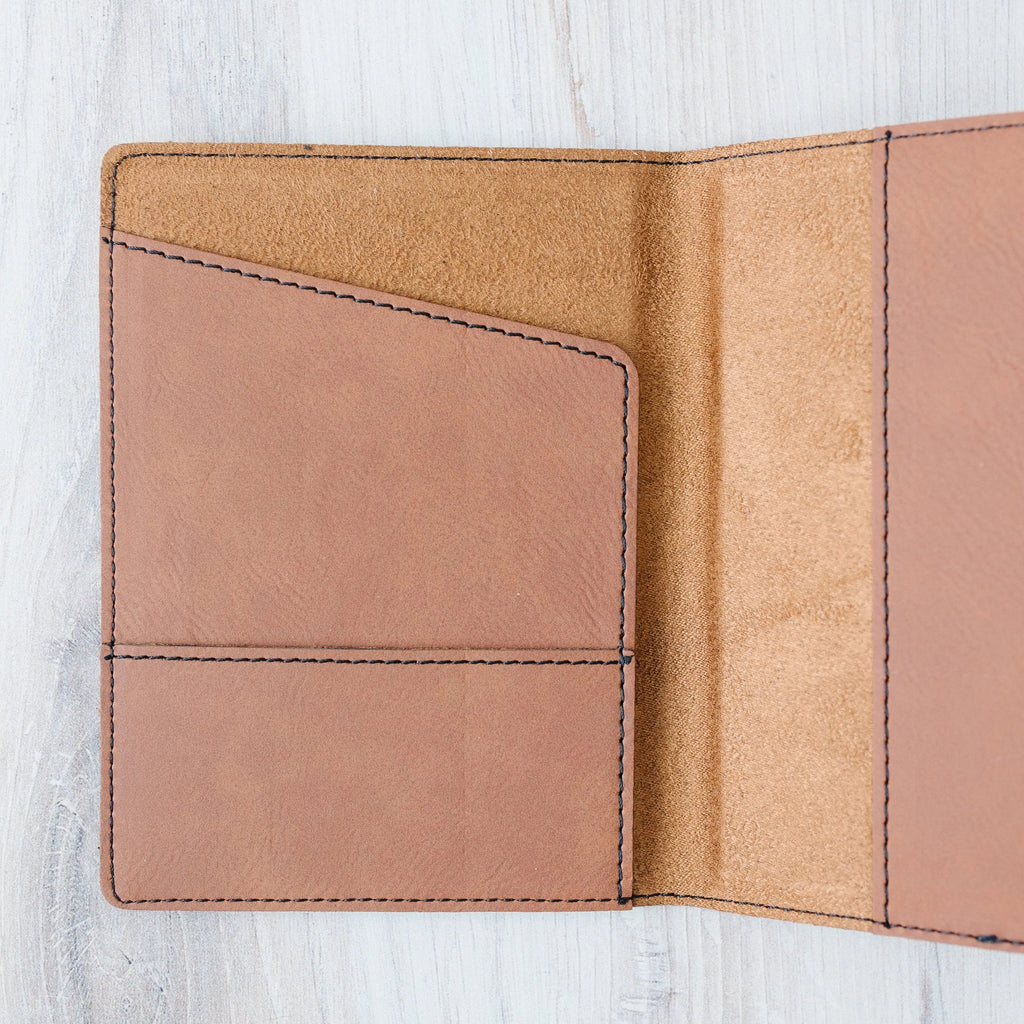 Interior of passport holder showing tan lining and stitched card pocket.