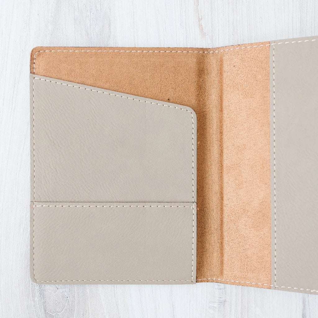 Passport holder interior with empty card sleeve and tan lining, stitched edges.