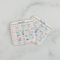 Set of 2 library due-date card coasters with white grid and red/blue stamped text.