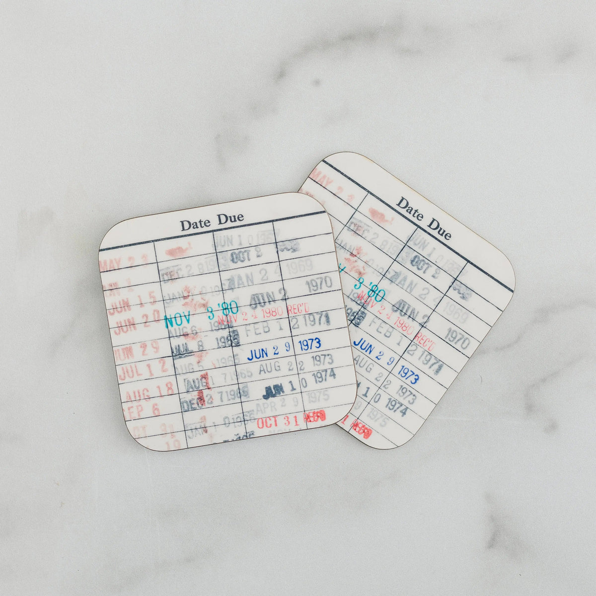 Set of 2 library due-date card coasters with white grid and red/blue stamped text.
