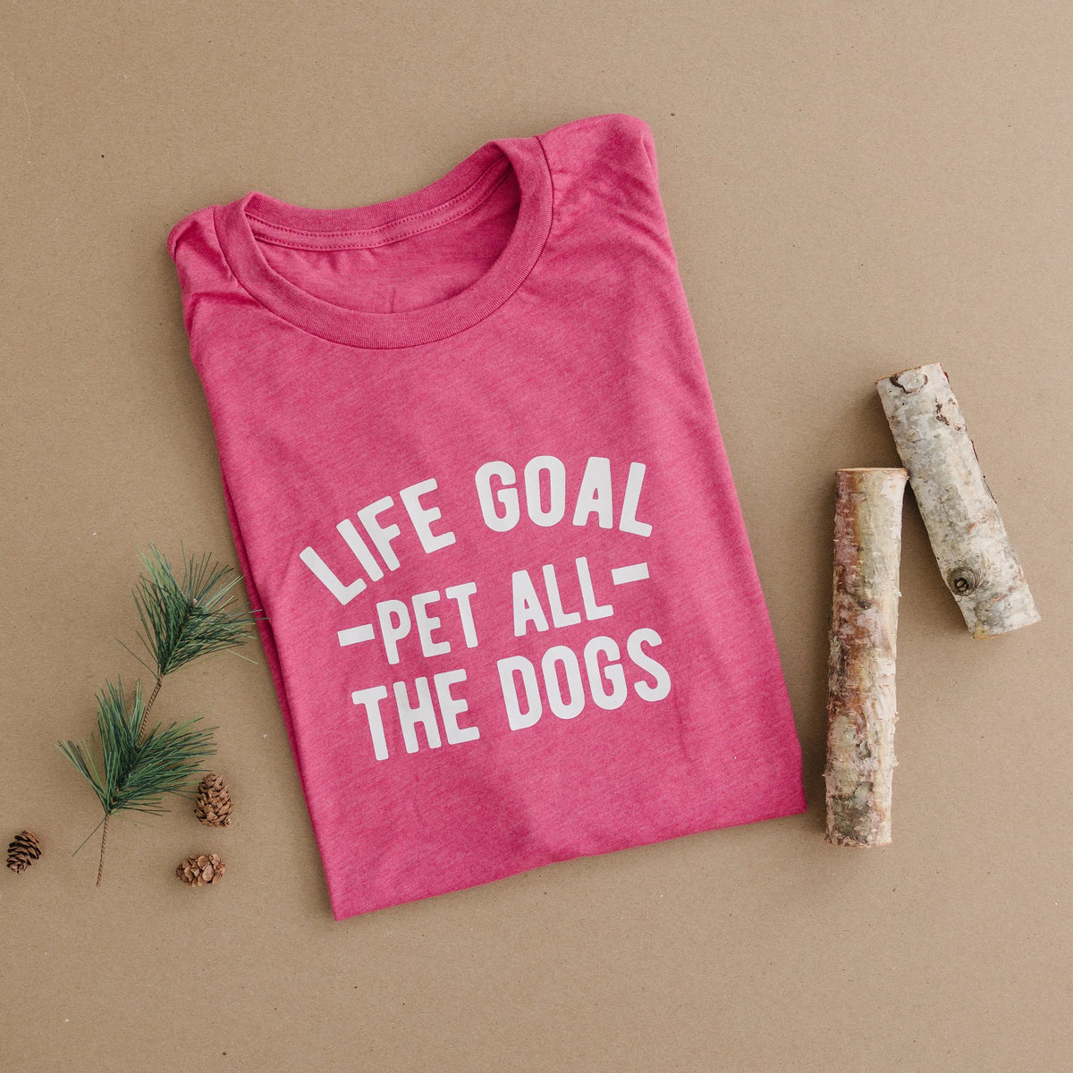 Pink T-shirt with white “Life Goal - Pet All - The Dogs” graphic, crew neck