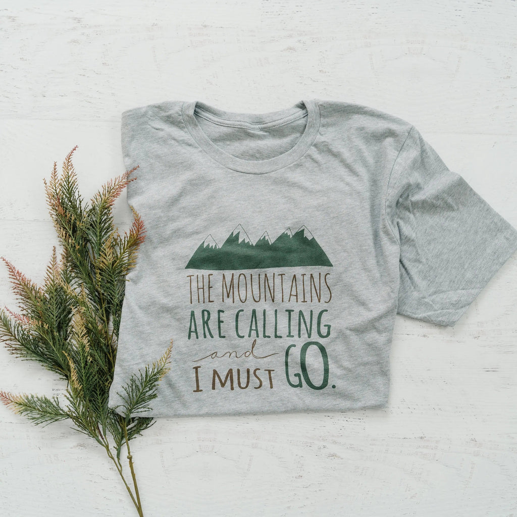 Gray crewneck unisex t-shirt with green mountains and "The Mountains are Calling" print