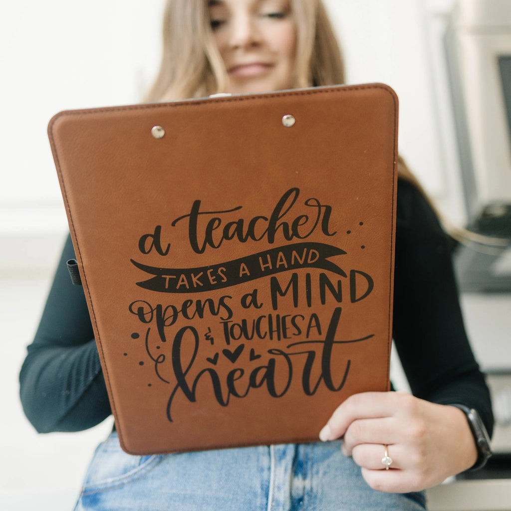 Brown leather clipboard held in hand, featuring a teacher quote graphic