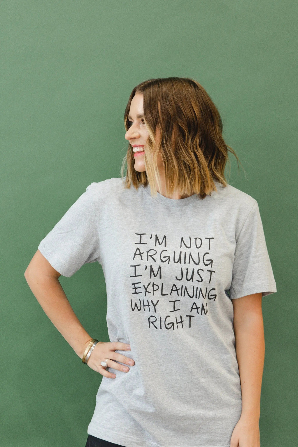 Model shown from behind in heather gray unisex T-shirt with back quote text: “why I am right”