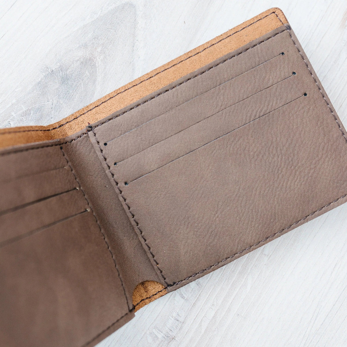 Leather wallet interior card slots with stitched lining in dark gray-brown