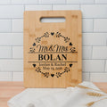 Light wood cutting board with handle slot and engraved 'Mr & Mrs BOLAN' design
