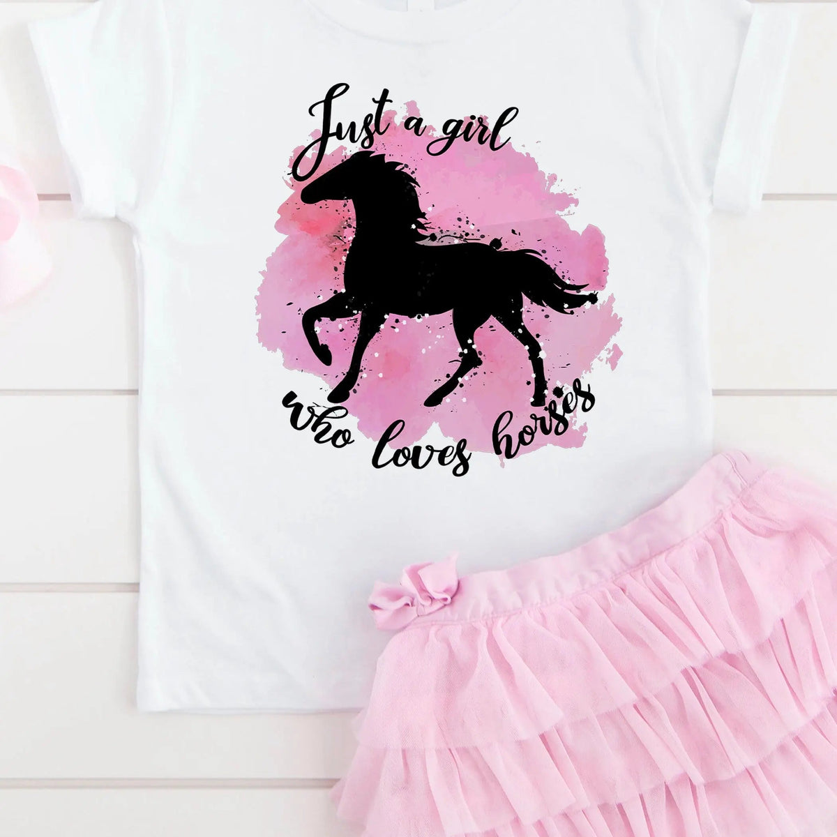Girls white crewneck T-shirt with black horse silhouette and pink watercolor graphic
