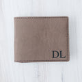 Light brown leather wallet with monogram DL and stitched edges