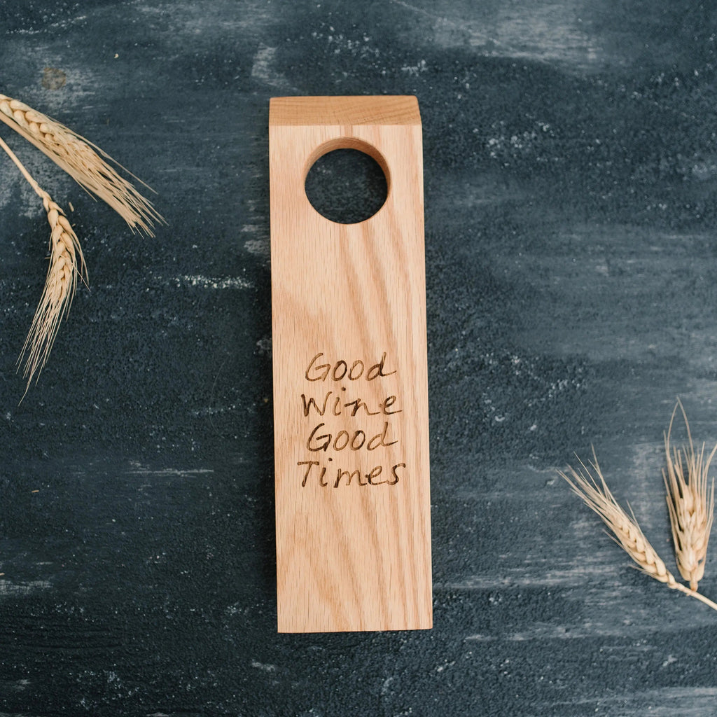 Wood wine bottle holder with round bottle hole and engraved 'Good Wine Good Times'