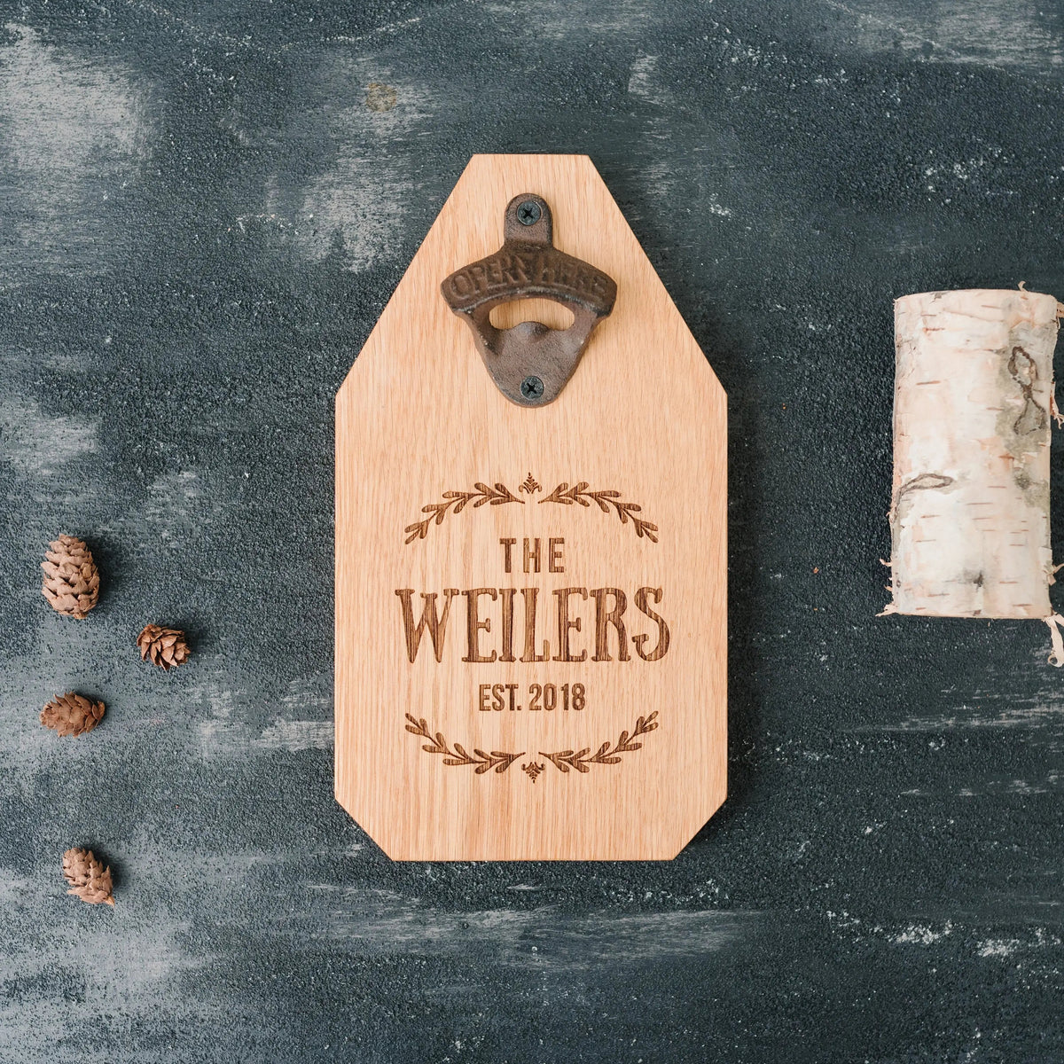 Light wood bottle opener sign with metal opener and engraved “THE WEILERS EST. 2018”.