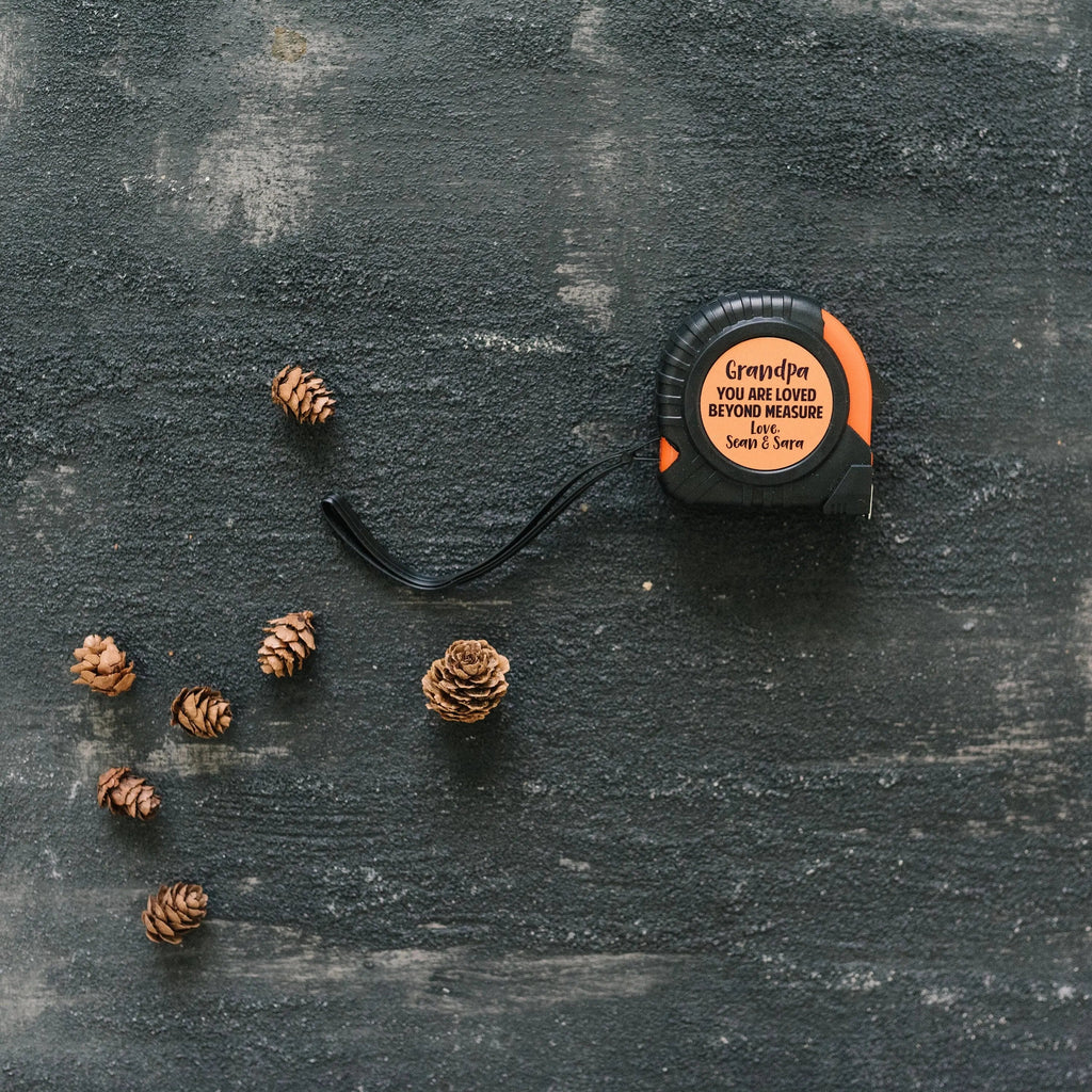 Personalized tape measure with custom 'Grandpa' text on orange circular label
