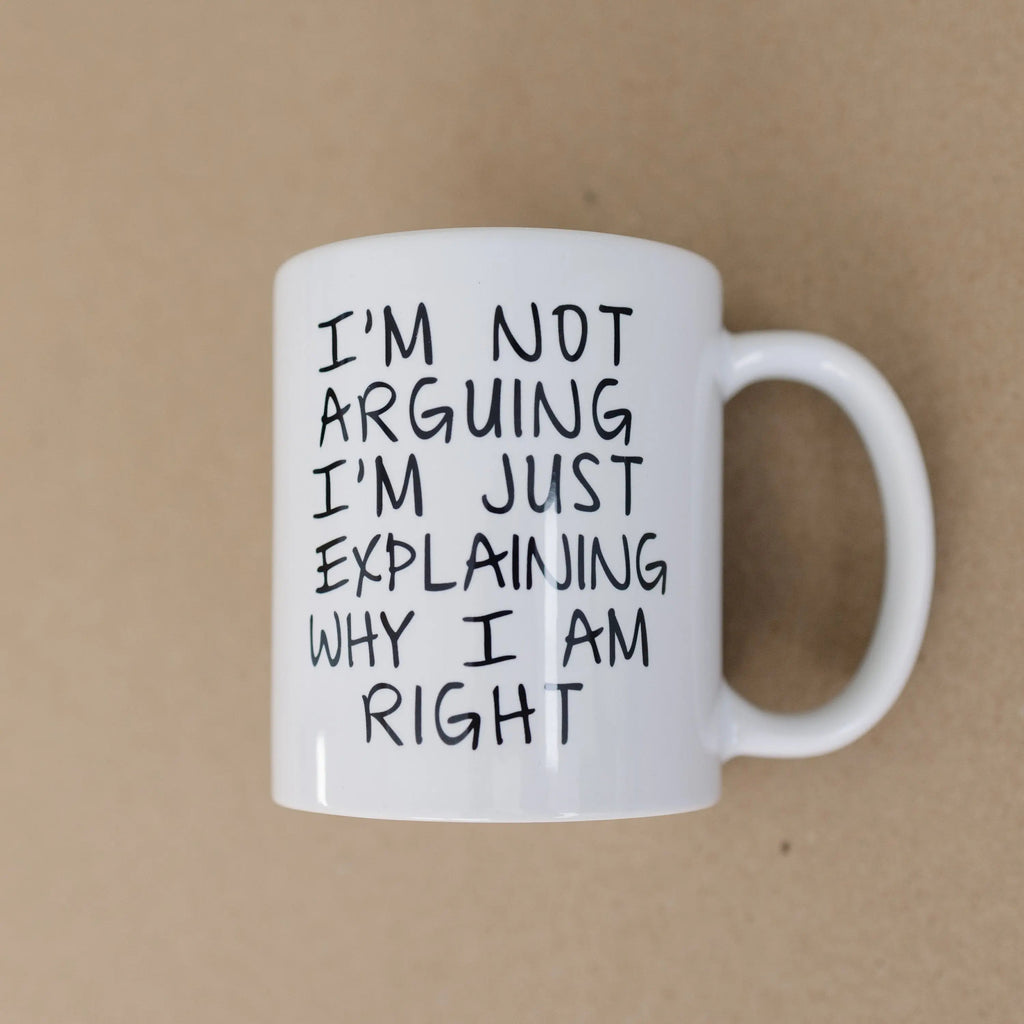 White ceramic mug with black humorous quote text, three-quarter view