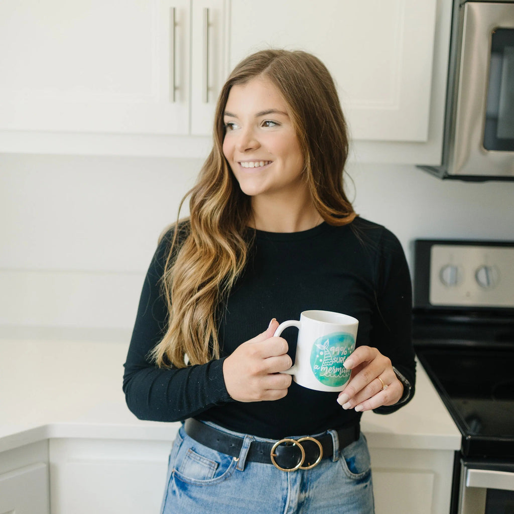 White mug with teal mermaid watercolor and '99% sure I'm a mermaid' slogan