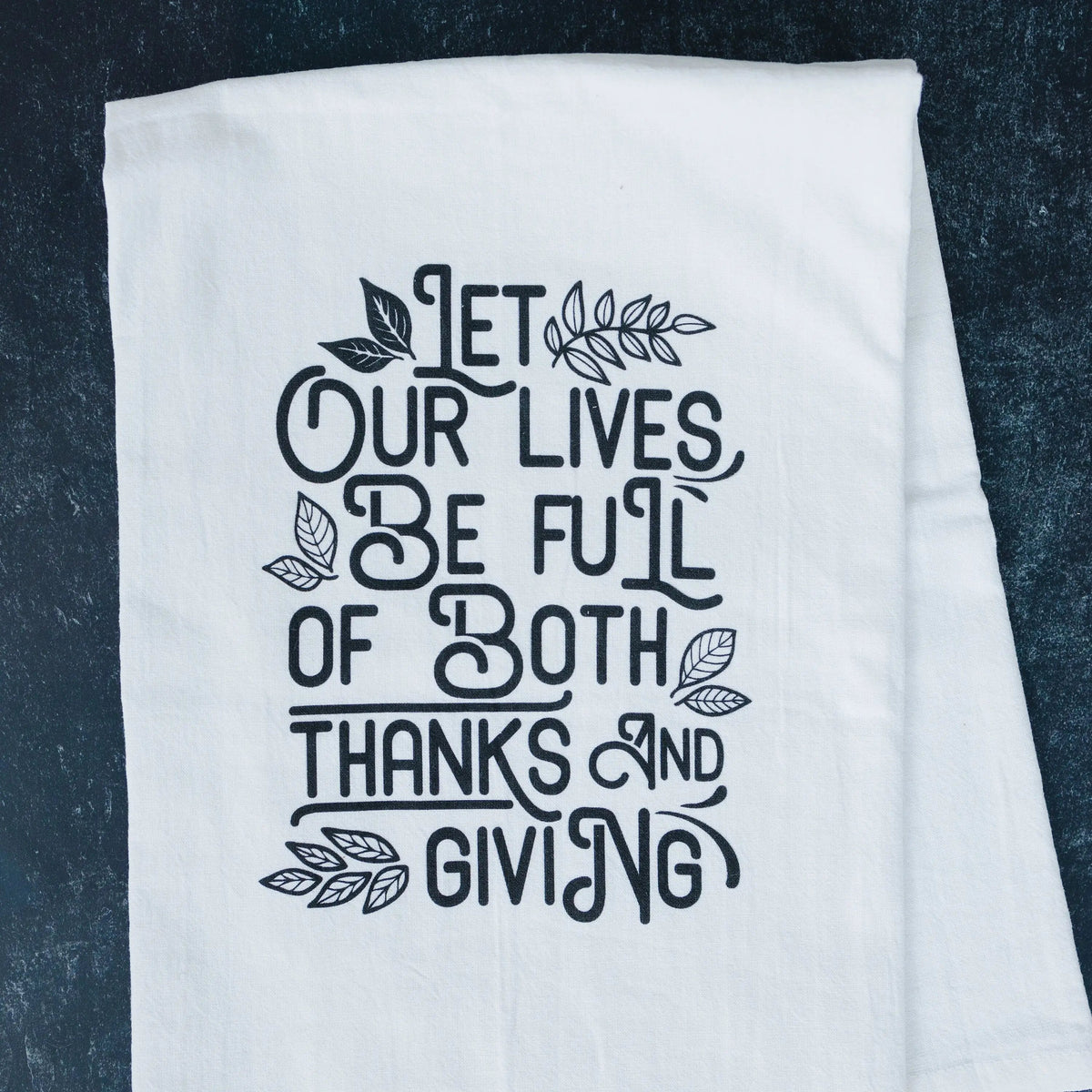 Thanksgiving kitchen towel, white fabric with black quote and leaf design on dark background