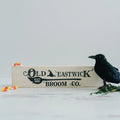 Cream wood framed mini sign reading Old Eastwick Broom Co.