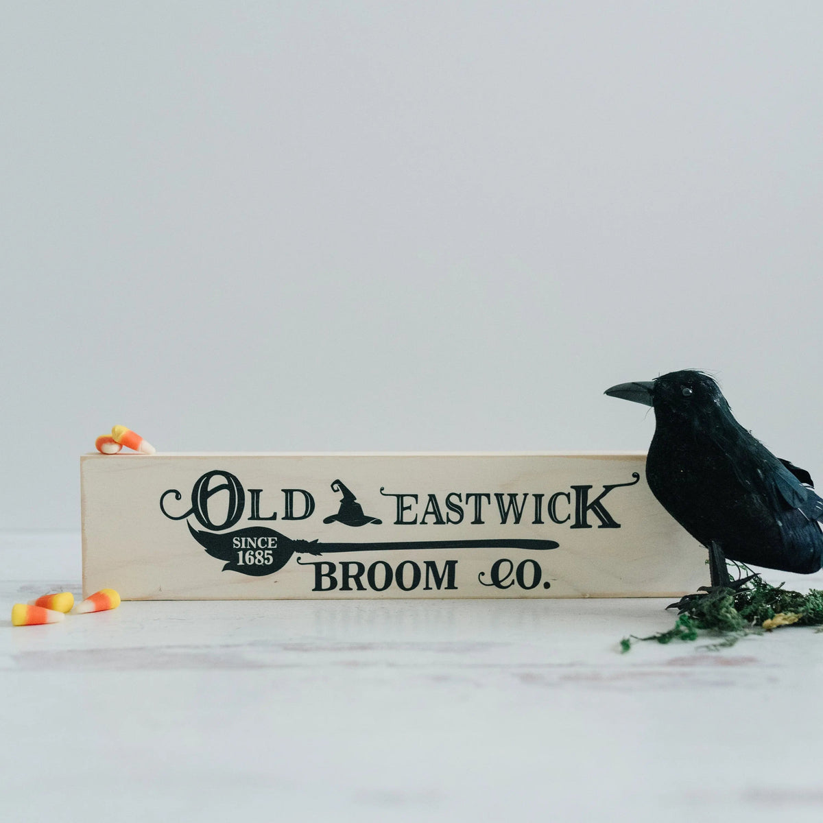 Cream wood framed mini sign reading Old Eastwick Broom Co.