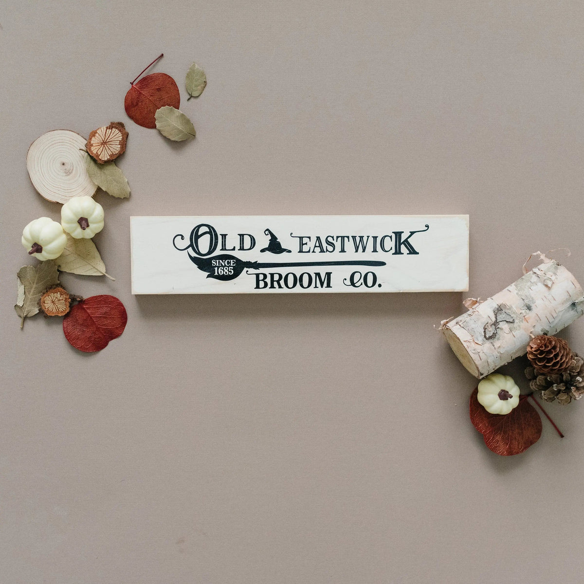 Cream wood framed mini sign with Old Eastwick Broom Co. lettering