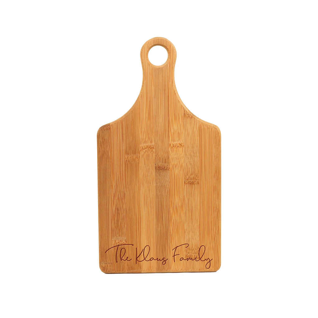 Wood charcuterie board with hanging hole and engraved "The Christen" family text.