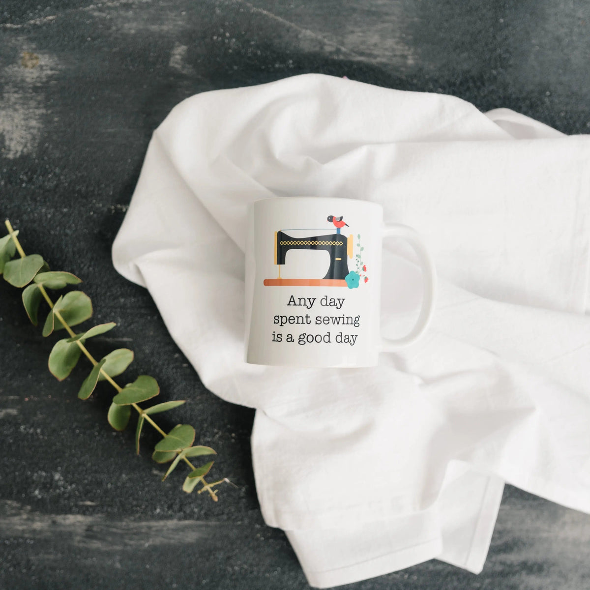 Small white sewing coffee mug with sewing machine illustration and quote on front