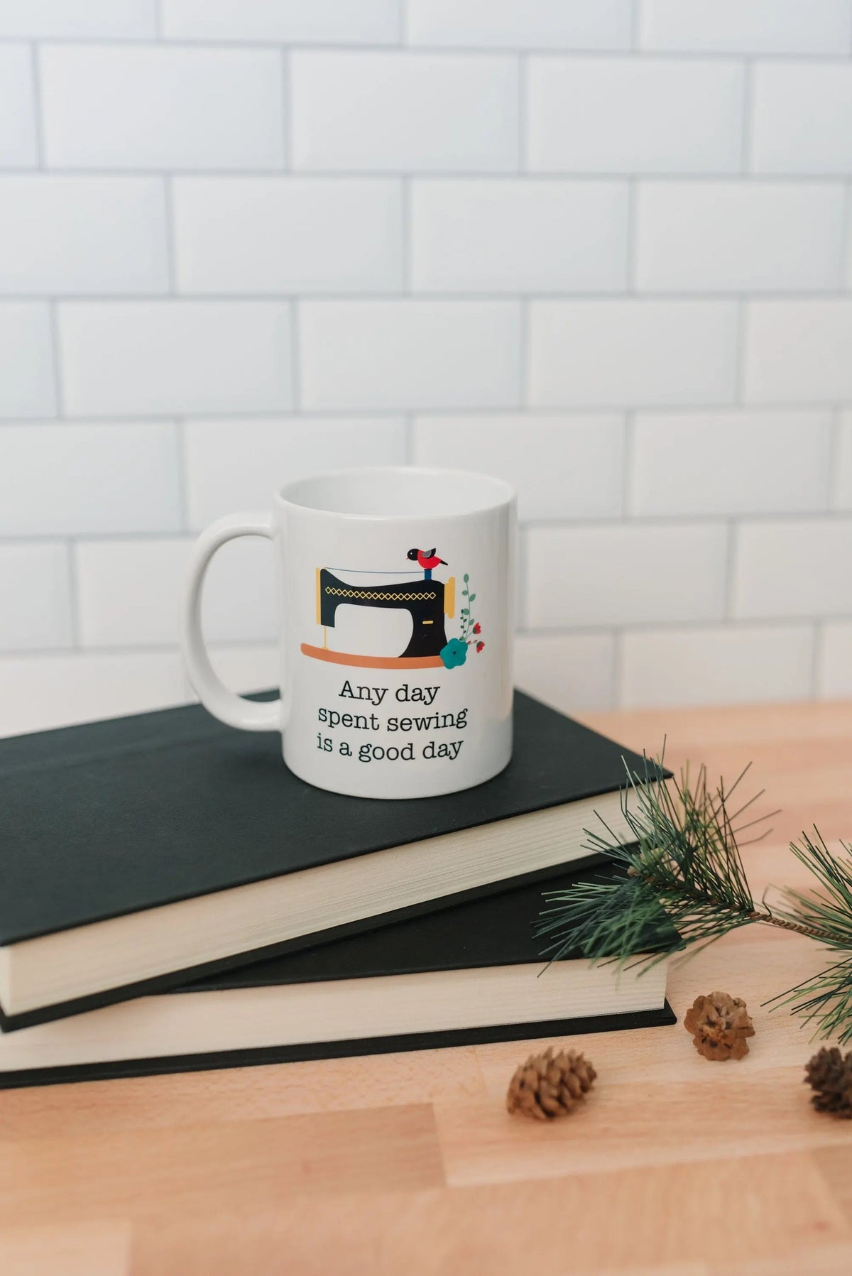 White sewing coffee mug with sewing machine illustration and "Any day spent sewing is a good day"