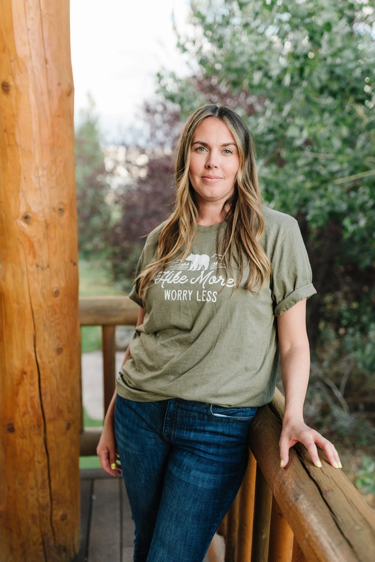 Olive green unisex t-shirt worn by model, bear “Hike More Worry Less” front print